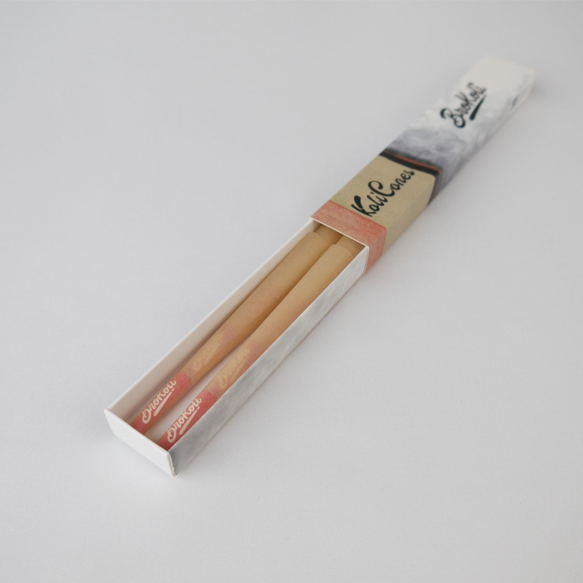 6er Pack Natural Brown Colored Tip KoliCones von BroKoli in einer stilvollen Verpackung. Die warmbraunen Cones sind teilweise aus der Box herausgezogen und zeigen das BroKoli-Logo auf den Red Tips.